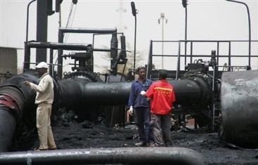 In this Tuesday, April 24, 2012 photo, Sudanese workers inspect burnt out oil pipes at the oil-rich border town of Heglig, Sudan (AP)