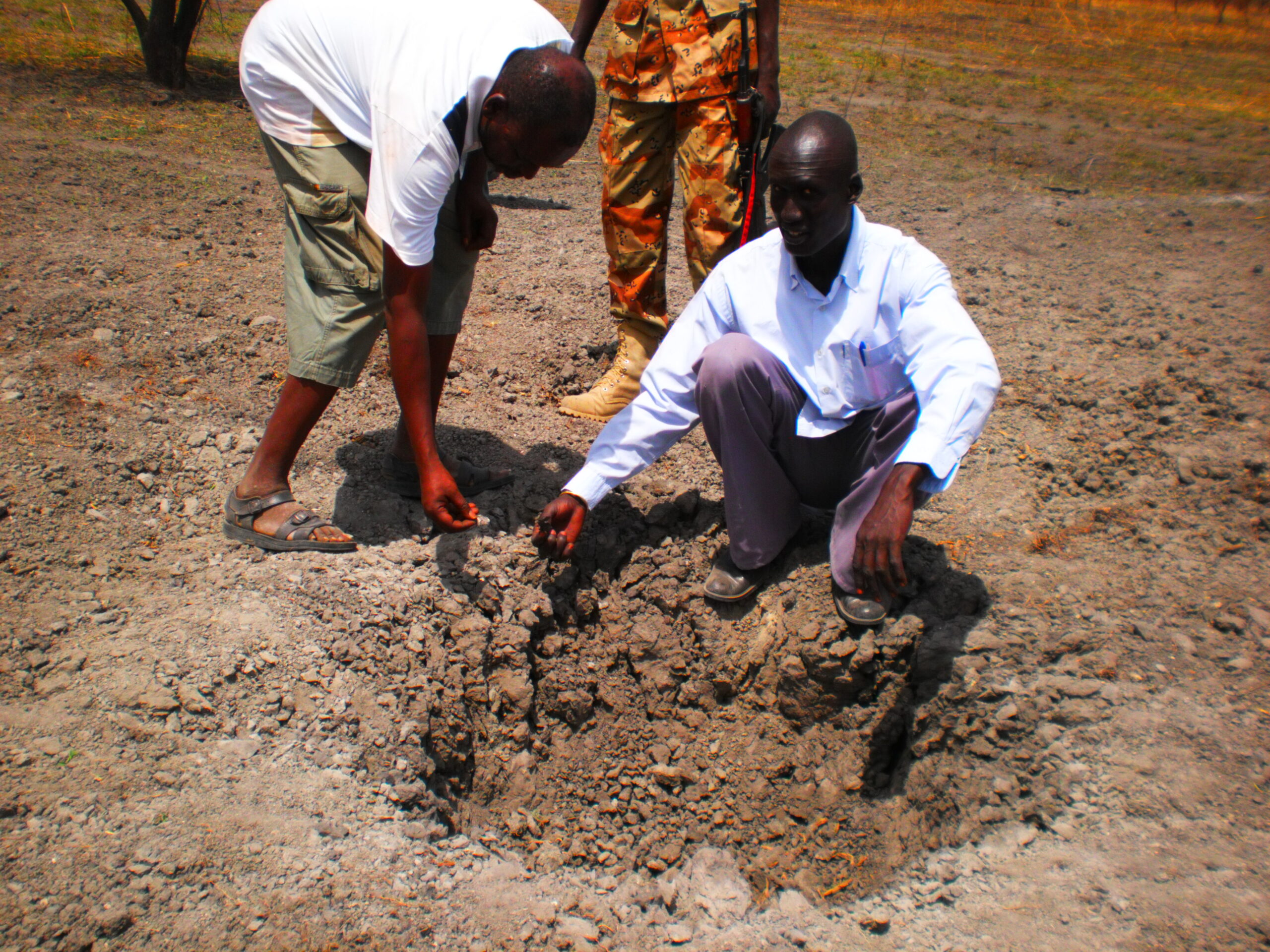 Chop Mut Machar, a resident of Guit County, showing the crater from an Antenov bomb dropped by the Sudan Armed Forces in Manga village, Unity State, South Sudan. 1 April 2012 (ST)