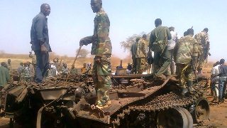 Sudanese troops on the remains of a tank in Heglig, March 27, 2012 (AFP)