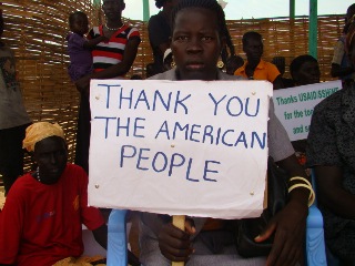 A beneficiary of SHiNE's two-year food assistance program holds a plague during the launch of the health and nutrition campaign in Warrap state, 12 April 2012 (ST)