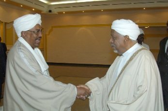 FILE PHOT0 - DUP leader Al-Mirghani (R) shakes hands with President Al-Bashir