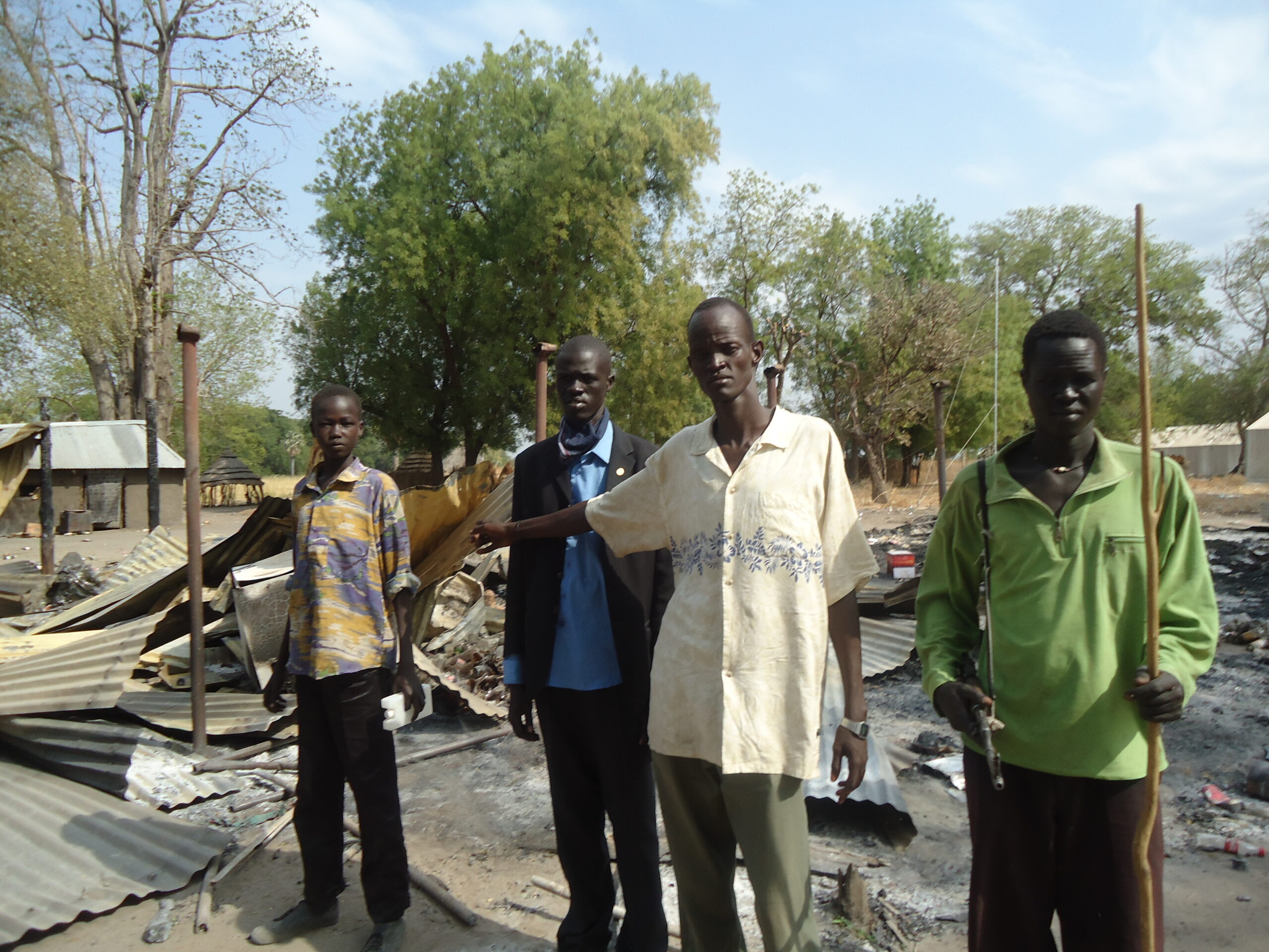 picture of young guy showing the remains of his burnt shop in Duk Padiet, January 2012.ST File.