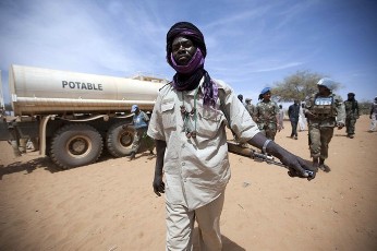A member of the rebel movement Sudan Liberation Army (SLA) - Abdul Wahid, escorts the delivery of 30,000 litres of water delivered by the African Union - United Nations Mission in Darfur's (UNAMID) peacekeeping troops from South Africa, in Forog, some 45km (28 miles) north of Kutum March 28, 2012 (Reuters)