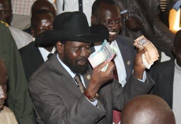 South Sudan President Salva Kiir holds freshly-minted notes of the new South Sudan pound, in Juba on July 18, 2011. Getty