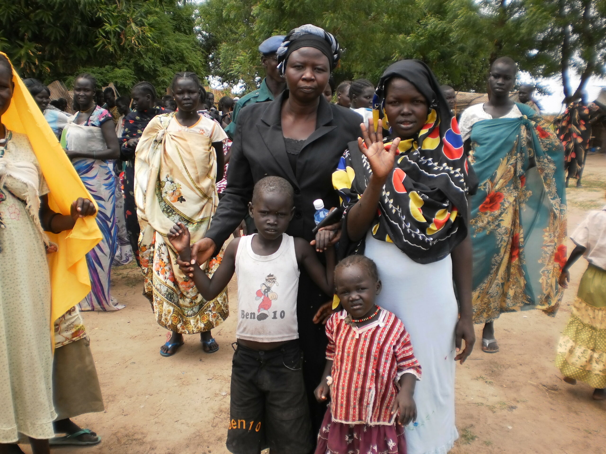 State Minister of Social developent Mrs Rebecca Kur Nyakai holding hand of children whose father die in fighting in SPLA barrack in Rubkotna 30 May 2012 (Bonifacio Taban/ST)