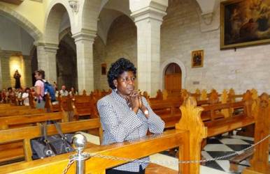 South Sudan’s Minister for Agriculture and Forestry, Betty Achan Ogwaro prays inside the Church of Nativity, in Bethlehem, during a visit to Israel in 2012 (Photo: Lomayat)
