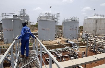 A worker walks at the power plant of an oil processing facility at an oilfield in Unity State April 22, 2012 (Reuters)