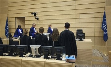 Judges Fatoumata Dembele Diarra, rear left, Bruno Cotte, center rear, and Christine Van Den Wyngaert, rear right, enter the Courtroom of the ICC during the closing statements in the trial against Congolese nationals Germain Katanga and Mathieu Ngudjolo in The Hague May 15, 2012 (AP)