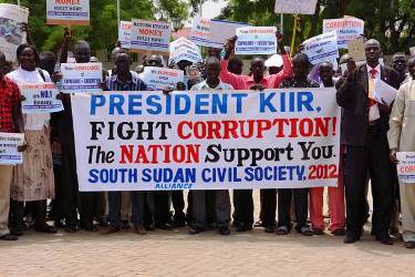 Civi society groups hols banners calling on the president Salva Kiir to punish officials involved in corruption cases (photo Larco Lomoyat)