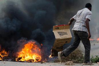 Photo of a Sudanese activist burning tire during Friday protests (Girifna, an anti-government group)