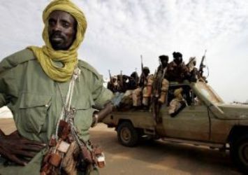 SLA fighters loyal to leader Minni Minawi ride at the back of a pick-up truck outside El-Fasher in North Darfur (Photo: Reuters)