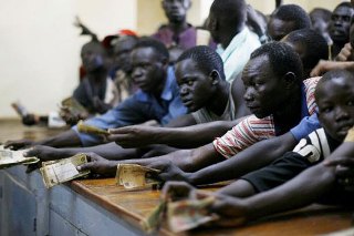 South Sudanese citizens jostle for SSDG at the exchange bureau (Reuters)