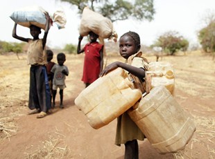 Sudanese refugees fleeing conflict:  children carry their family's belonging as they go to Yida refugee camp in South Sudan outside Tess village in the rebel-held territory of the Nuba Mountains in South Kordofan (Reuters)