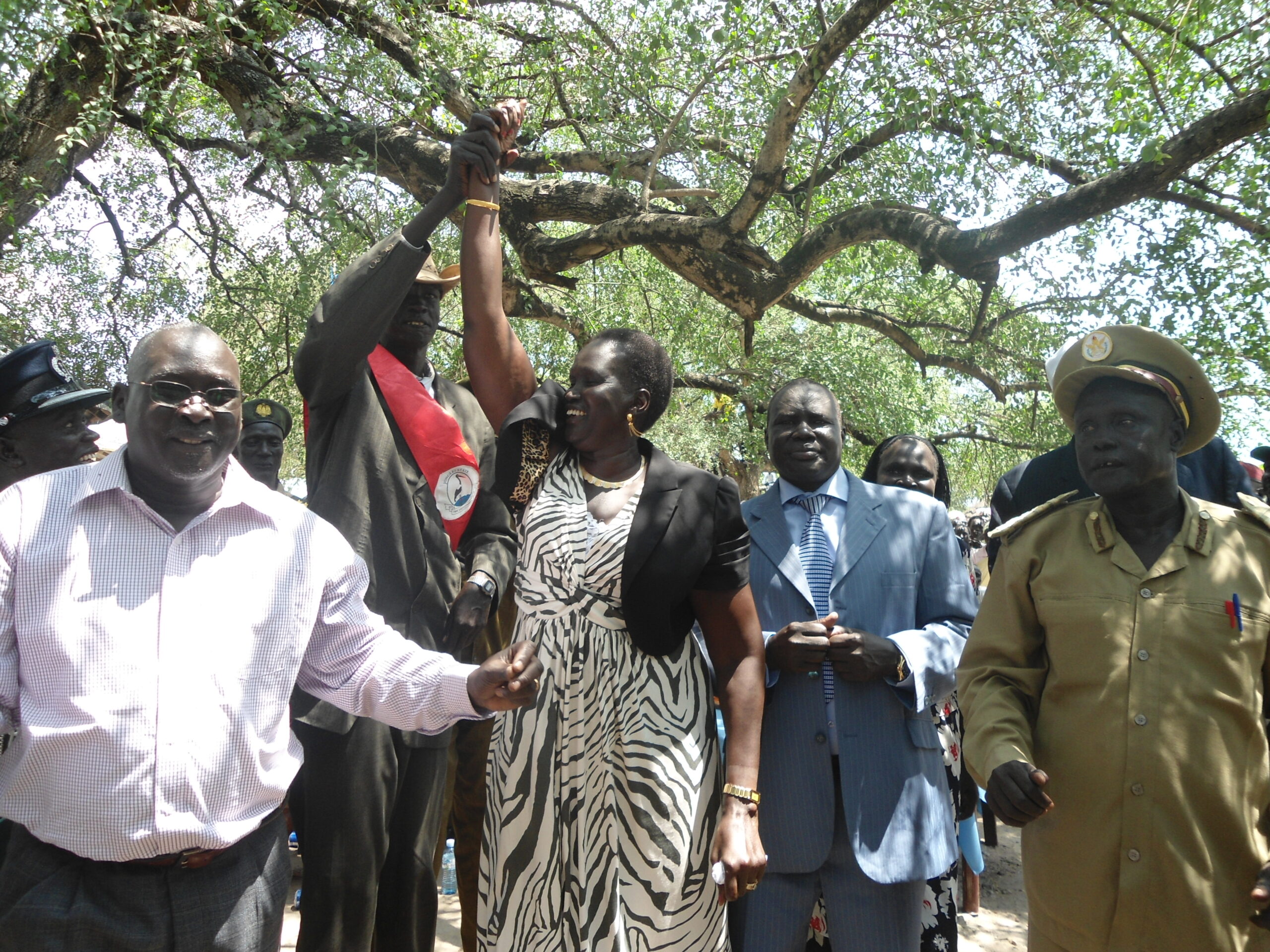 From the left Brig. General Atem Manyok, Rebecca Nyandeng Garang, with her right hands raised by a chief, Koch Deng Koch, (Maroldit), The commissioner of Twic East County, Dau Akoi, after being amazed by one of the artists, Nyan-paleu at Panyagoor, 9 July 2012  (ST)
