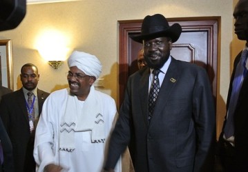 Sudanese President Omer al-Bashir (Centre Left) smiles after shaking hands with his South Sudanese counterpart Salva Kiir (Centre Right) following a meeting in the Ethiopian capital Addis Ababa, on July 14, 2012 (Getty)