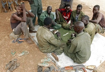 SPLA-N fighters take a break near Jebel Kwo village in the rebel-held territory of the Nuba Mountains in South Kordofan, May 2, 2012.   (Reuters))