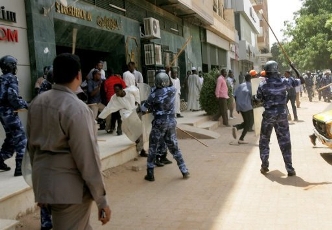 Police beating demonstrators during protests in the capital Khartoum last year