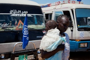 a_south_sudanese_returnee_from_khartoum_carries_a_baby_as_she_arrives_in_south_sudan_s_capital_juba_may_14_2012._reu.jpg
