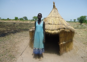 A woman in Adiem village, Warrap state stand in front of her  pit latrine (©UNICEF 2012)