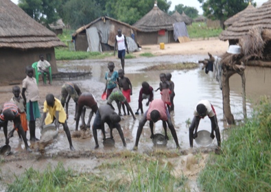 The the children of James Kur, bailing water from their home, Pakuau, Bor, Jonglei, August 7, 2012 (ST)