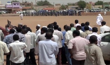 FILE PHOTO - Sudanese protesters gather as riot policemen stand guard during a demonstration in the capital Khartoum on July 13, 2012 (GETTY)