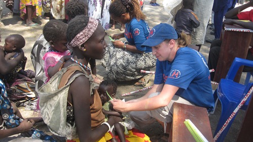 A humanitarian worker attends to a malnourished child in Pibor county, Jonglei state, February 02, 2012 (ST)