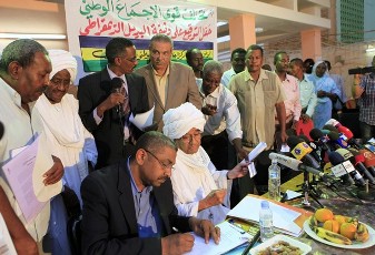 FILE PHOTO - Supporters from Sudan's main opposition parties sign documents requesting for democratic alternatives to the one-party rule at the Democratic Unity Party headquarters in Omdurman July 4, 2012 (REUTERS)