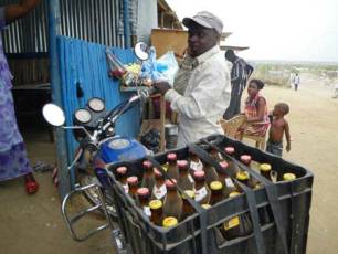A motorcycle taxi delivers beer to one of the thousands of local bars in the south Sudan capital Juba, March 18, 2009 (Reuters)