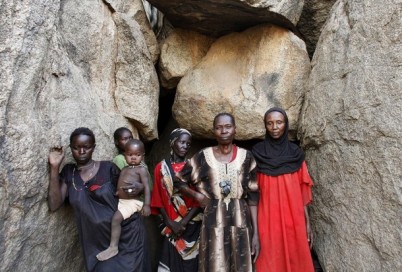 Women stand in front of a cave in Bram village in the Nuba Mountains, South Kordofan, April 28, 2012. (Reuters)