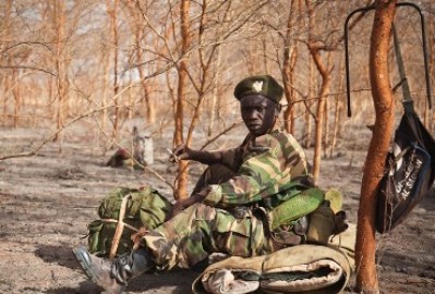 A picture taken on April 15, 2012 shows a soldier of the South-Sudan's SPLA waiting amongst acacia trees at the front lines just north of Heglig (Getty)