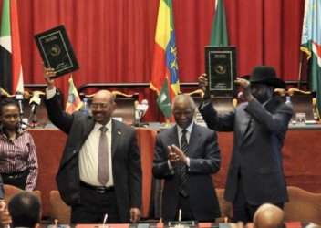 President Omer Al-Bashir, left, and  President Salva Kiir, right, gesture after the signing ceremony of a deal on economic and security agreements on Thursday, Sept. 27, 2012 in Addis Ababa (AP)