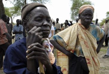 People displaced by fighting in Abyei wait to be registered at a UN WFP distribution point in the village of Abathok May 19, 2008. (Reuters)