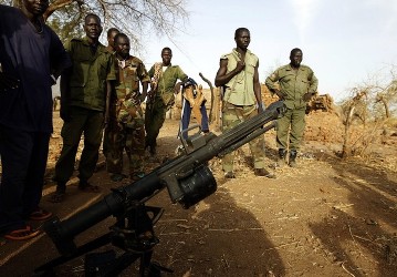 SPLA-N fighters stand in front of a grenade launcher captured from Sudan's Armed Forces (SAF) near Gos village in the rebel-held territory of the Nuba Mountains in South Kordofan, May 1, 2012.  (Reuters)