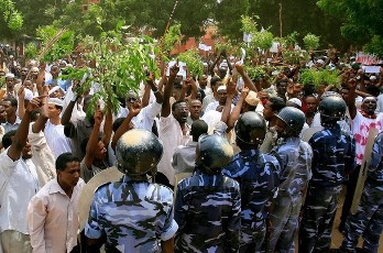 Sudanese policemen stand guard opposite demonstrators during a protest against an amateur film mocking Islam outside the German embassy in Khartoum on September 14, 2012 (GETTY)