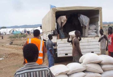 WFP food assistance being offloaded from a truck at a distribution site in the South Kordofan capital Kadugli. (Photo WFP)