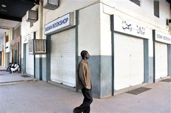 A man walks past a closed bookshop in Khartoum (AFP)
