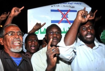 Sudanese demonstrators hold banners and chant anti-Israeli slogans during a protest in Khartoum on October 24, 2012, as the Sudanese cabinet prepared to hold an urgent meeting regarding the Israeli missile strike that hit a military factory. Sudan has accused Israel of the attack and has threatened to take action.
