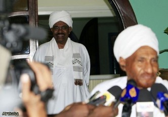 FILE PHOTO - NUP leader Al-Sadiq Al-Mahdi speaking to reporters following a meeting with President Al-Bashir who is standing behind