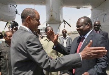 Pagan Amum, right, head of a delegation from South Sudan, is received by Sudan's Idris Mohamed Abdel-Gadir after the delegation's arrival in Khartoum, Sudan, Thursday, March 22, 2012 (AP)