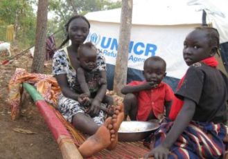 Sudanese refugees rest next to their UNHCR tent inside South Sudan. (photo UNHCR)