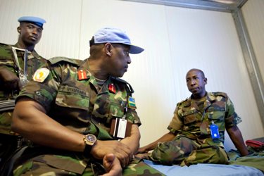 UNAMID Force Commander, Patrick Nyamvumba, left, talks to an injured peacekeeper after an ambush Tuesday, in El Geneina, Sudan, Wednesday, Oct. 3, 2012. (photo UNAMID)