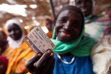 A woman shows her ration card at the voucher distribution center in Abu Shouk camp for internally displaced persons (IDP), North Darfur, on 18 October 2012, ( photo by Albert González Farran - UNAMID)