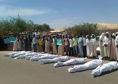 A picture by published by Najla Elshaikh, a Darfur activist on its facebook page, showing the bodies of the 10 victims of 2 Nov attack on Sigili village surrounded by their relatives in Al-Fashir on Saturday 3 November 2012.