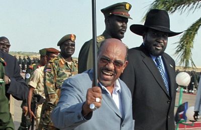 A picture taken on January 9, 2009 shows Sudan's President Omer Al-Bashir (C) and First Vice President Salva Kiir arriving at Upper-Nile State capital city (Getty)