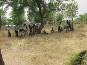 Residents in Pochala town on Feb. 15, 2012 look on as UNMISS helicopter take off (ST)