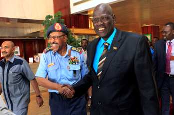 FILE- Sudan defense minister Abdel Rahim Mohammed Hussein (L) and his South Sudanese counterpart John Kong Nyuon