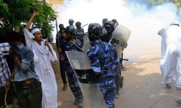 FILE PHOTO - Sudanese policemen try to disperse protesters demonstrating against an amateur film mocking Islam outside the German embassy in Khartoum. Photograph: Ashraf Shazly/AFP/Getty Images