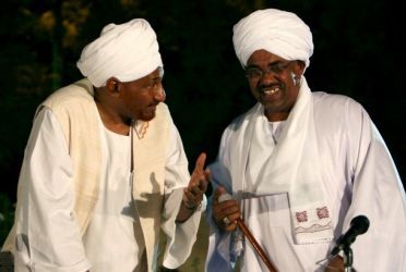 FILE - Sudan's President Omer Hassan Al-Bashir (R) talks with opposition's National Umma Party leader and former Prime Minister al-Sadiq Al-Mahdi on 24 March 2011 (Reuters)