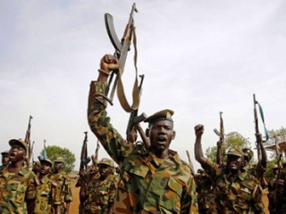 South Sudan's SPLA soldiers hold up their weapons as they shout at a military base in Bentiu 22 April 2012 (Reuters)