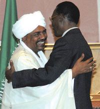 Sudanese president Omer Hassan al-Bashir (right) receives Chad president Idris Deby upon his arrival in Khartoum, Sudan on 8 February 2010 (AP Photo/Abd Raouf)